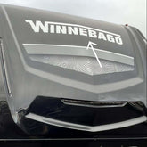 Winnebago logo on the front of a large vehicle, likely an RV.